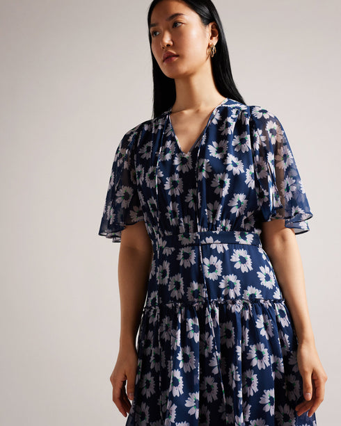 MARLLEE-Dresses-Introducing MARLLEE, your new wardrobe essential. With its sophisticated design and attention-grabbing details, this midi dress is bound to make a statement. Adorned with a stunning painted floral print and featuring short fluted sleeves, it boasts a floaty A-line silhouette that exudes elegance. Style it with heels for an elegant outing with friends or pair it with ankle boots for the daytime.The shell of this product is made of 100% recycled polyester. Using recycled polyester helps divert